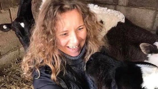 Lisa playing with a cow